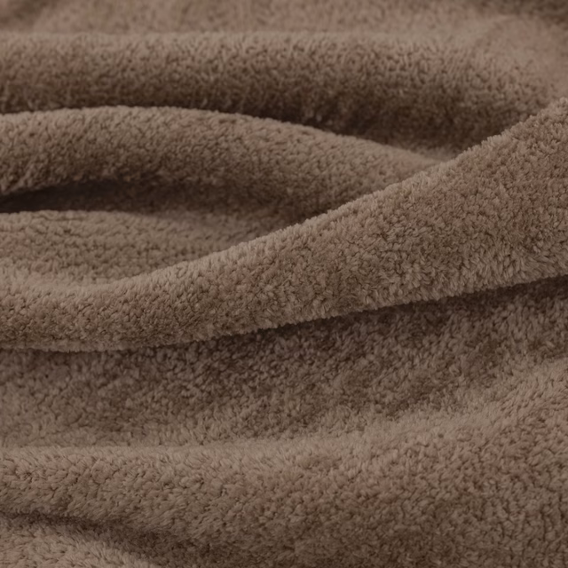 Warm chestnut-brown plush pile folded into soft, shadowed ridges