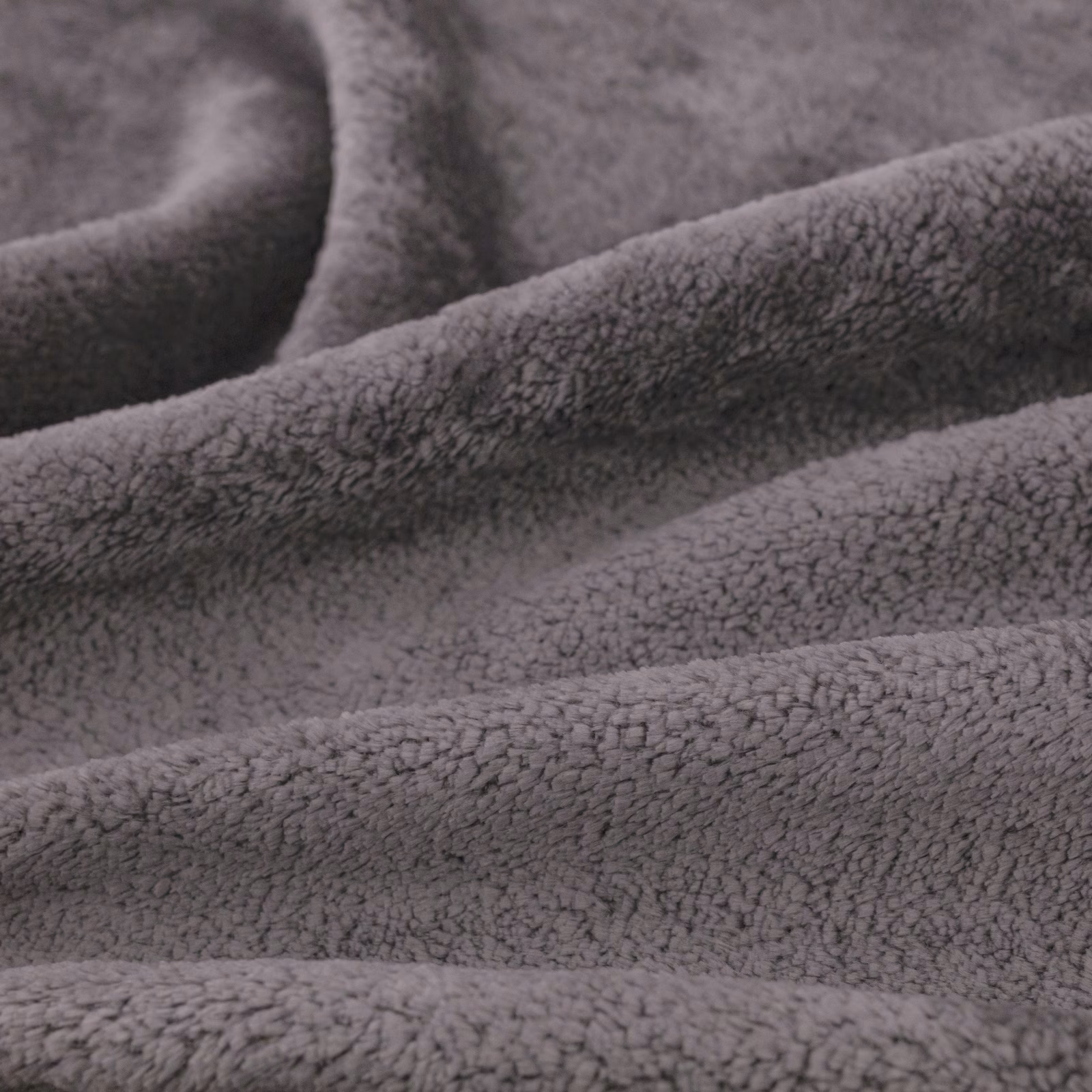 Close-up of cool chinchilla-grey fabric with dense plush nubby pile in soft folds