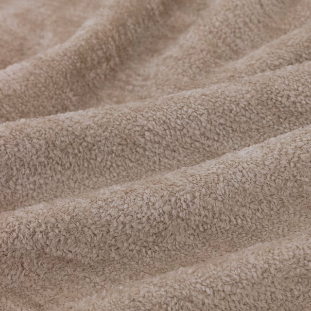 Warm taupe Cecconi Dune swatch with dense nubby pile and softly waved folds
