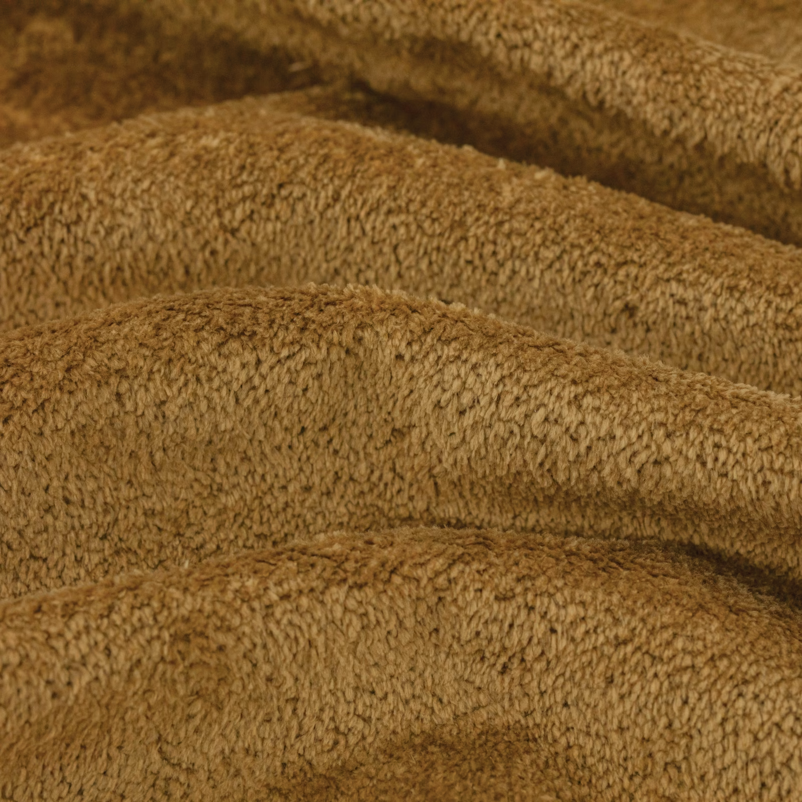 Warm honey-brown bouclé upholstery swatch with dense looped pile and folded tonal shading