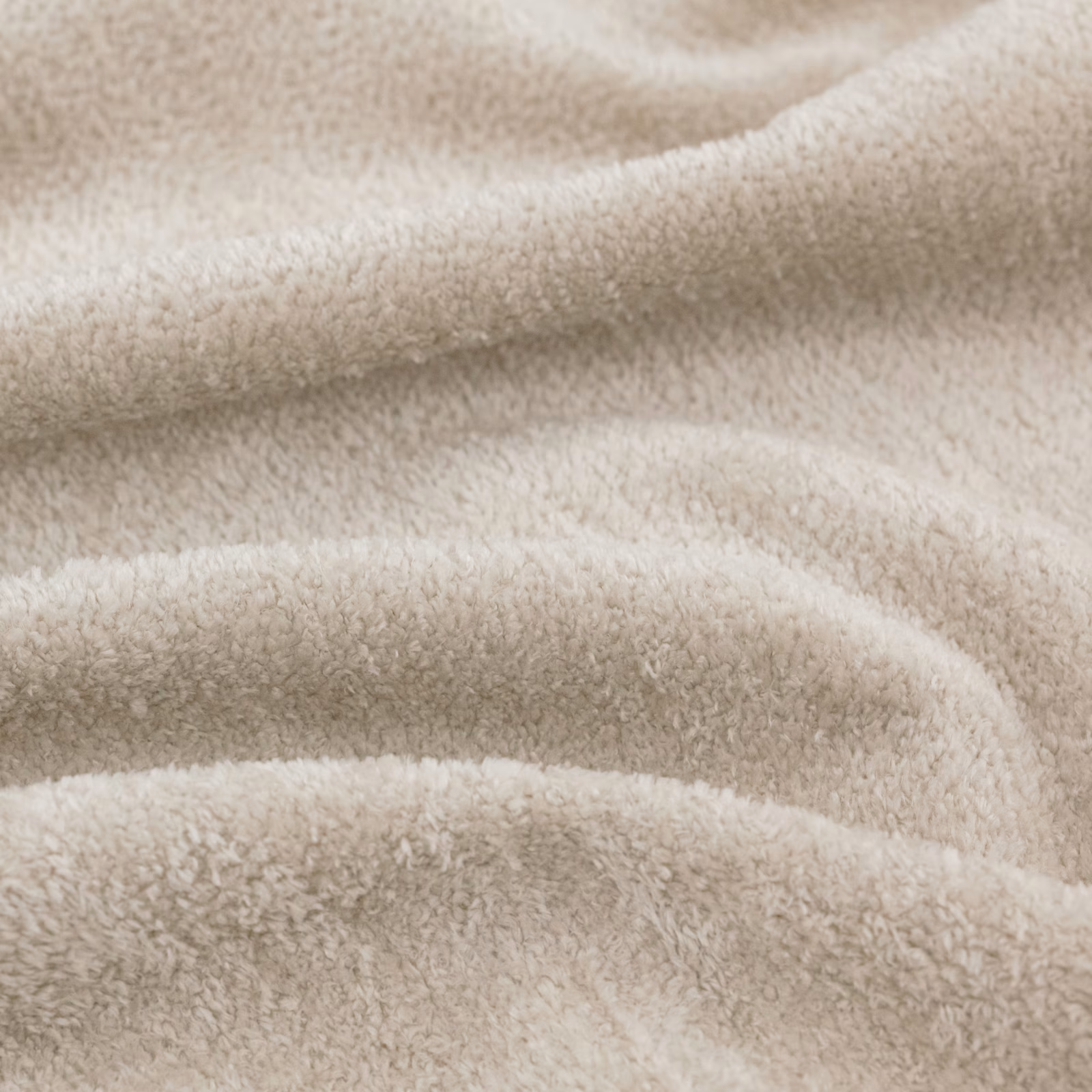 Warm ivory plush fabric with a softly napped surface in gathered folds