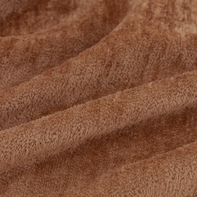 Warm kiln-brown plush fabric swatch with directional pile and shaded folded texture