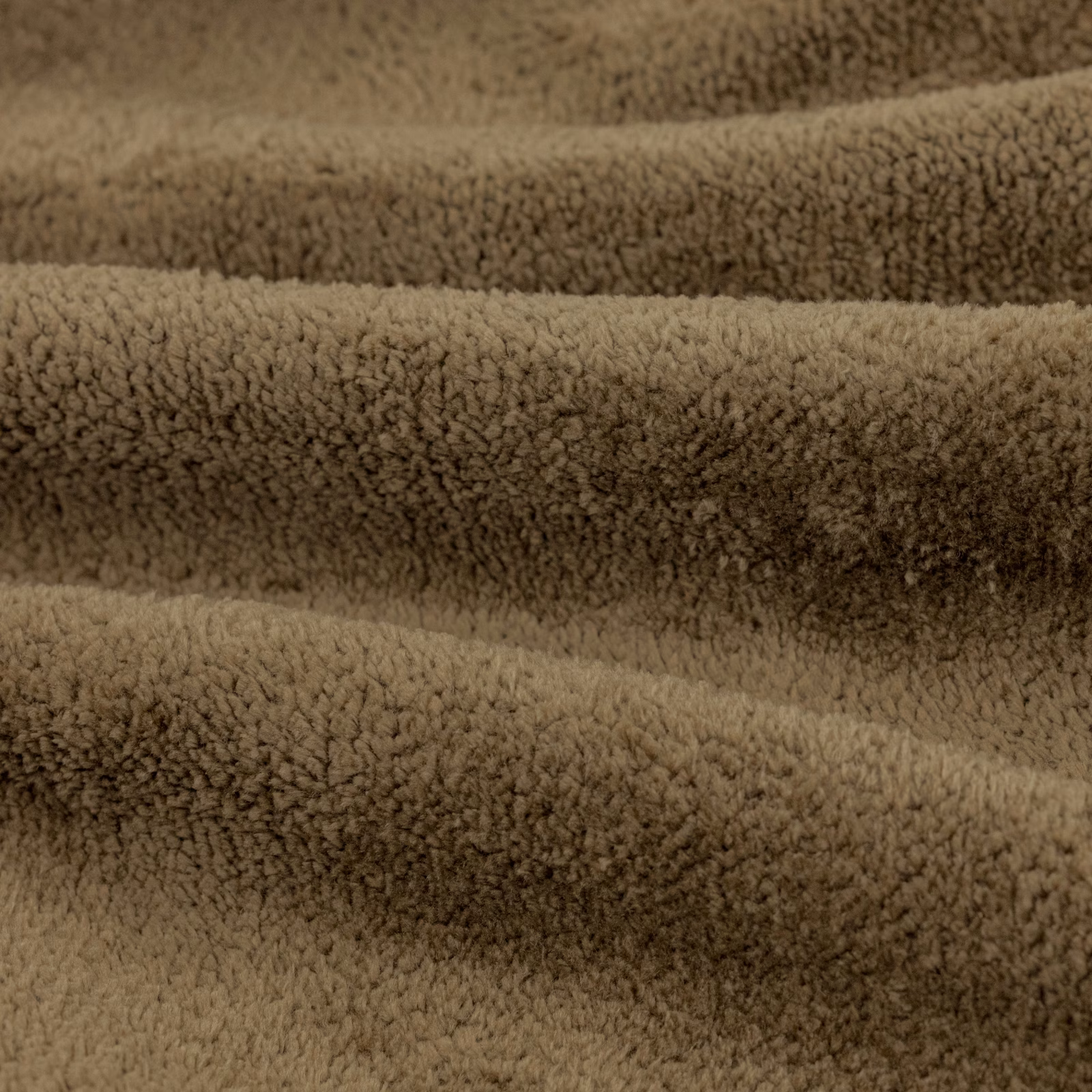 Close-up of warm lichen-taupe fabric with dense curled plush pile and shadowed ridges