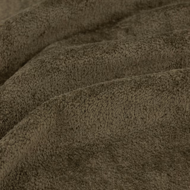 Close view of dense moss-olive looped pile with softly shadowed folds