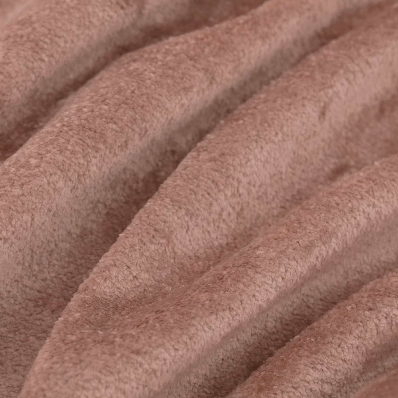 Dusky rose-pink plush fabric folded into broad ridges, showing soft directional pile and tonal shadows