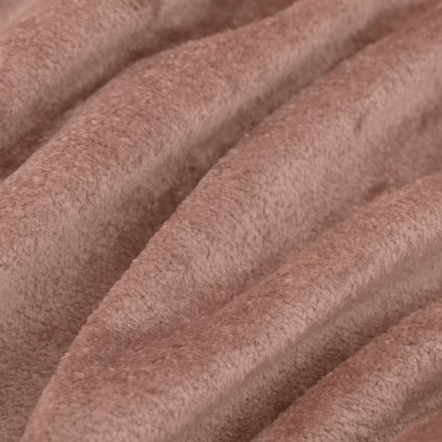 Dusky rose-pink plush fabric folded into broad ridges, showing soft directional pile and tonal shadows