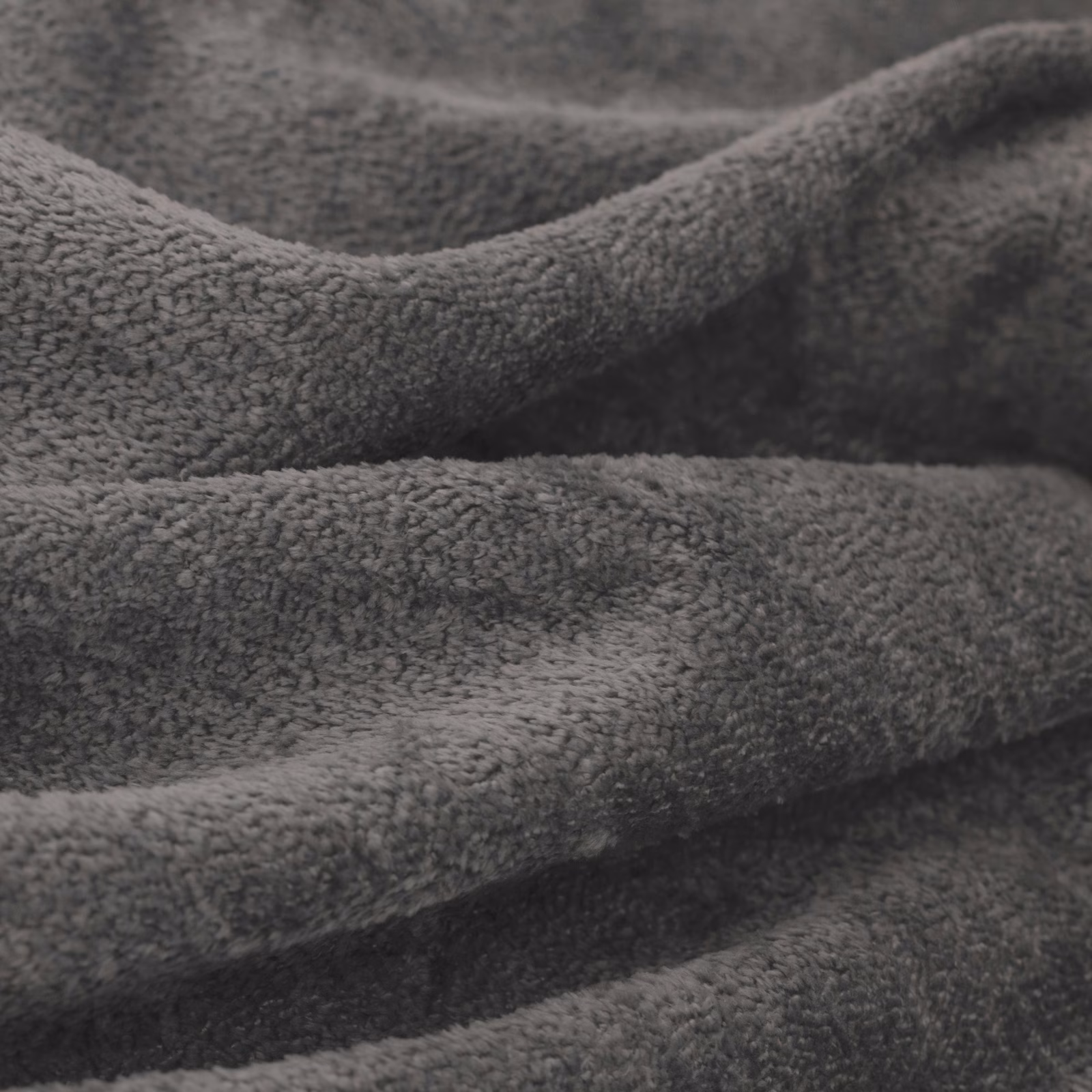 Close-up of deep storm-grey plush textile with softly napped, folded surface