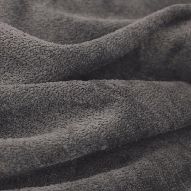 Close-up of deep storm-grey plush textile with softly napped, folded surface