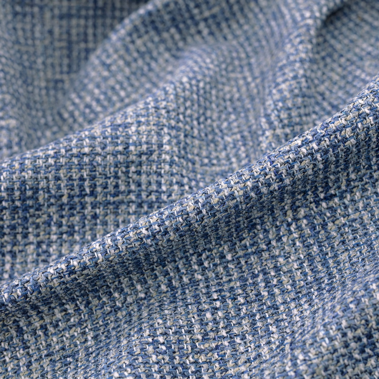 Folded Chanel Indigo swatch showing heathered indigo and pale blue textured weave