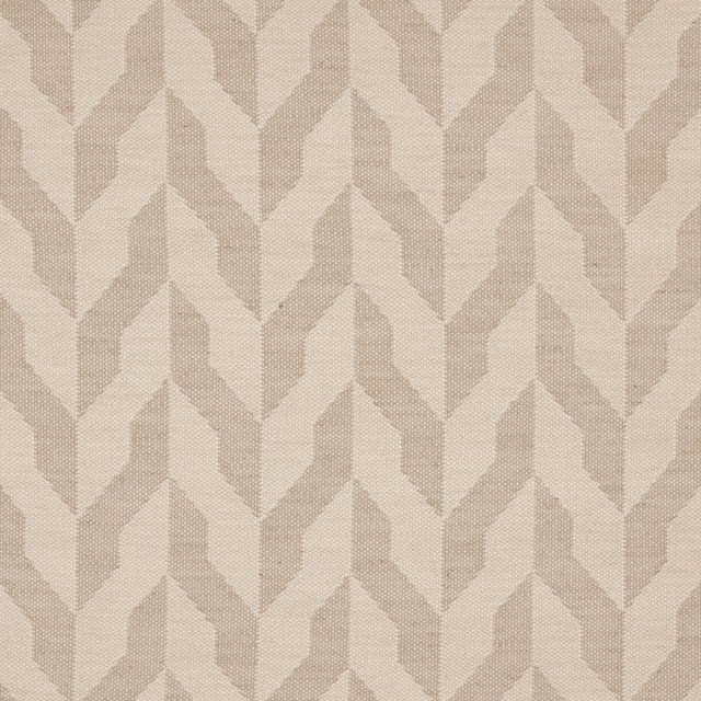Close-up of a natural ivory chevron woven upholstery fabric with tonal beige texture