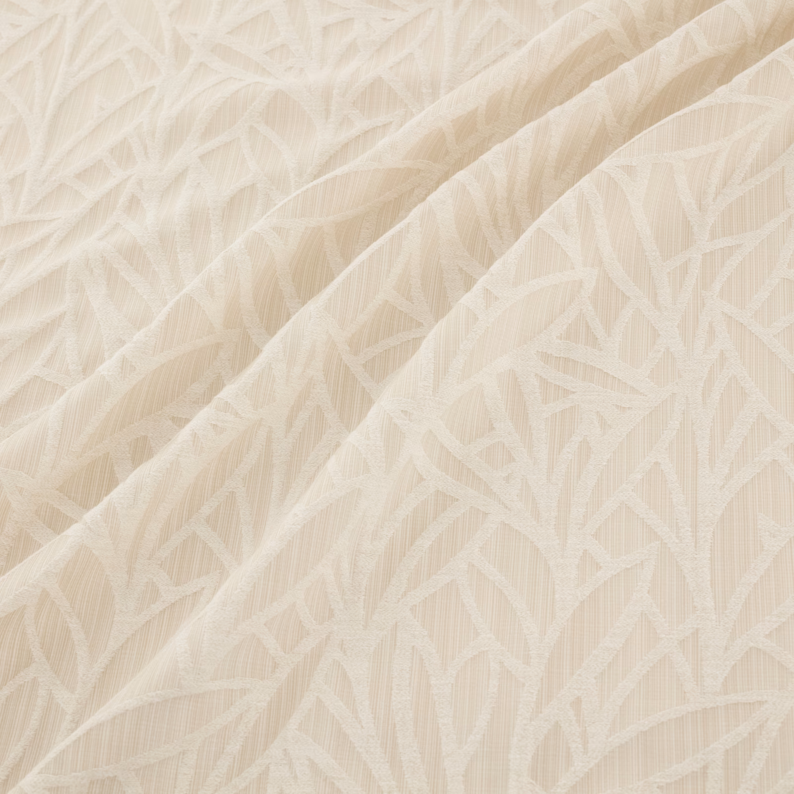 Warm ivory woven fabric with raised angular leaf motifs and softly textured folds