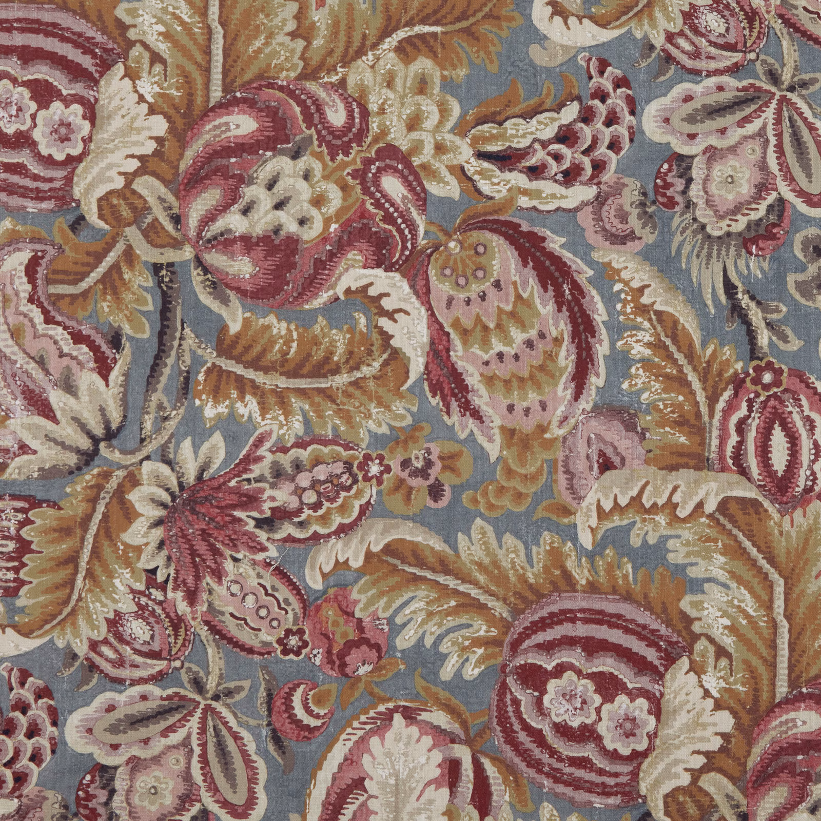 Dusty blue paisley fabric with berry-red blooms, ivory petals and tan woven detail