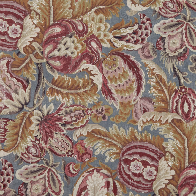 Dusty blue paisley fabric with berry-red blooms, ivory petals and tan woven detail