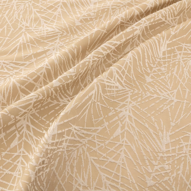 Warm copper-beige fabric with ivory abstract branch lines in softly folded textured cloth