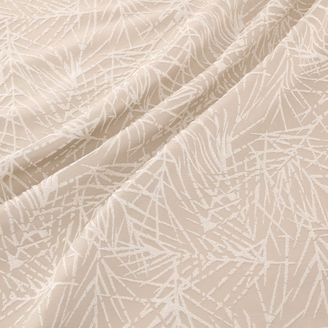 Warm ecru woven fabric with ivory branching botanical lines and softly folded texture