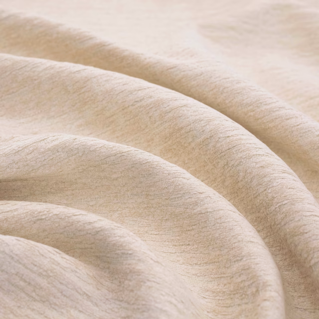 Warm ivory textile with a softly brushed strié surface folded into broad waves