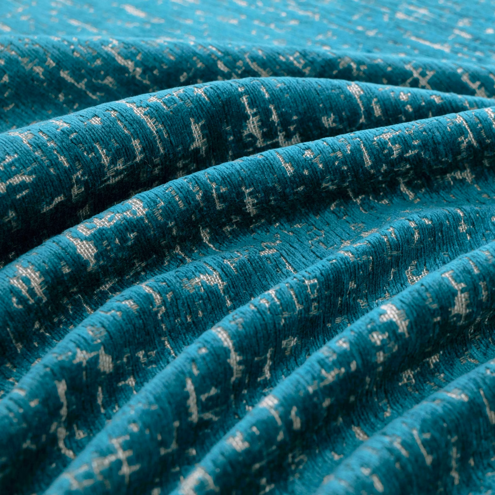 Deep teal woven fabric with pale flecks and pronounced folded texture