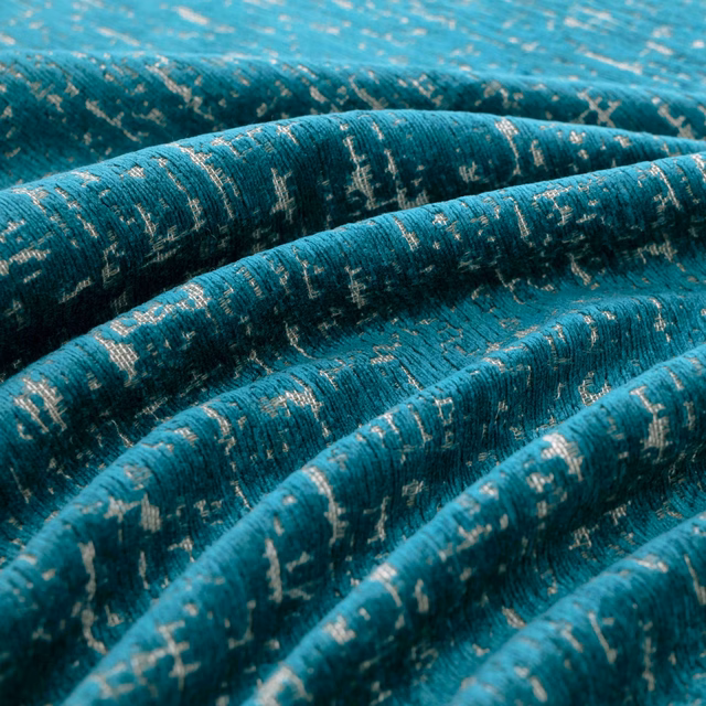 Deep teal woven fabric with pale flecks and pronounced folded texture