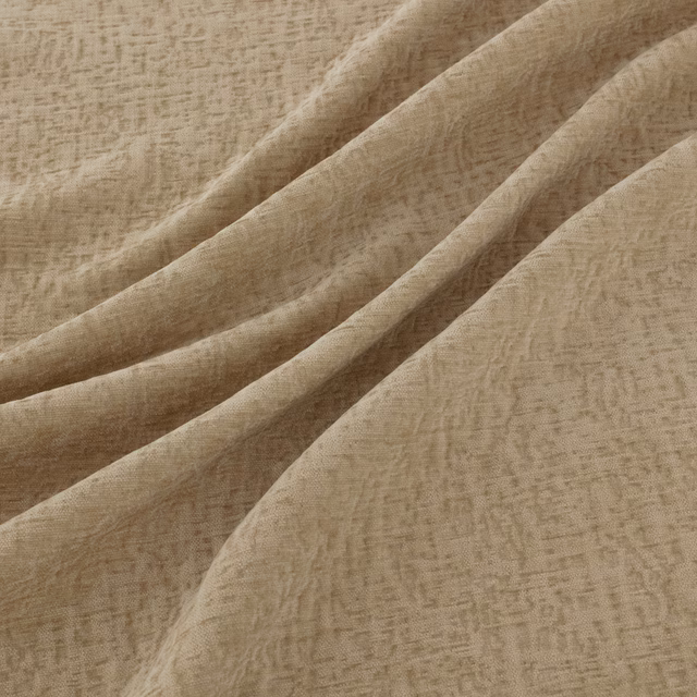 Warm ivory cream fabric with irregular woven texture arranged in soft folds