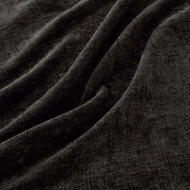 Deep charcoal Magnet fabric with crosshatched texture falling into soft folds