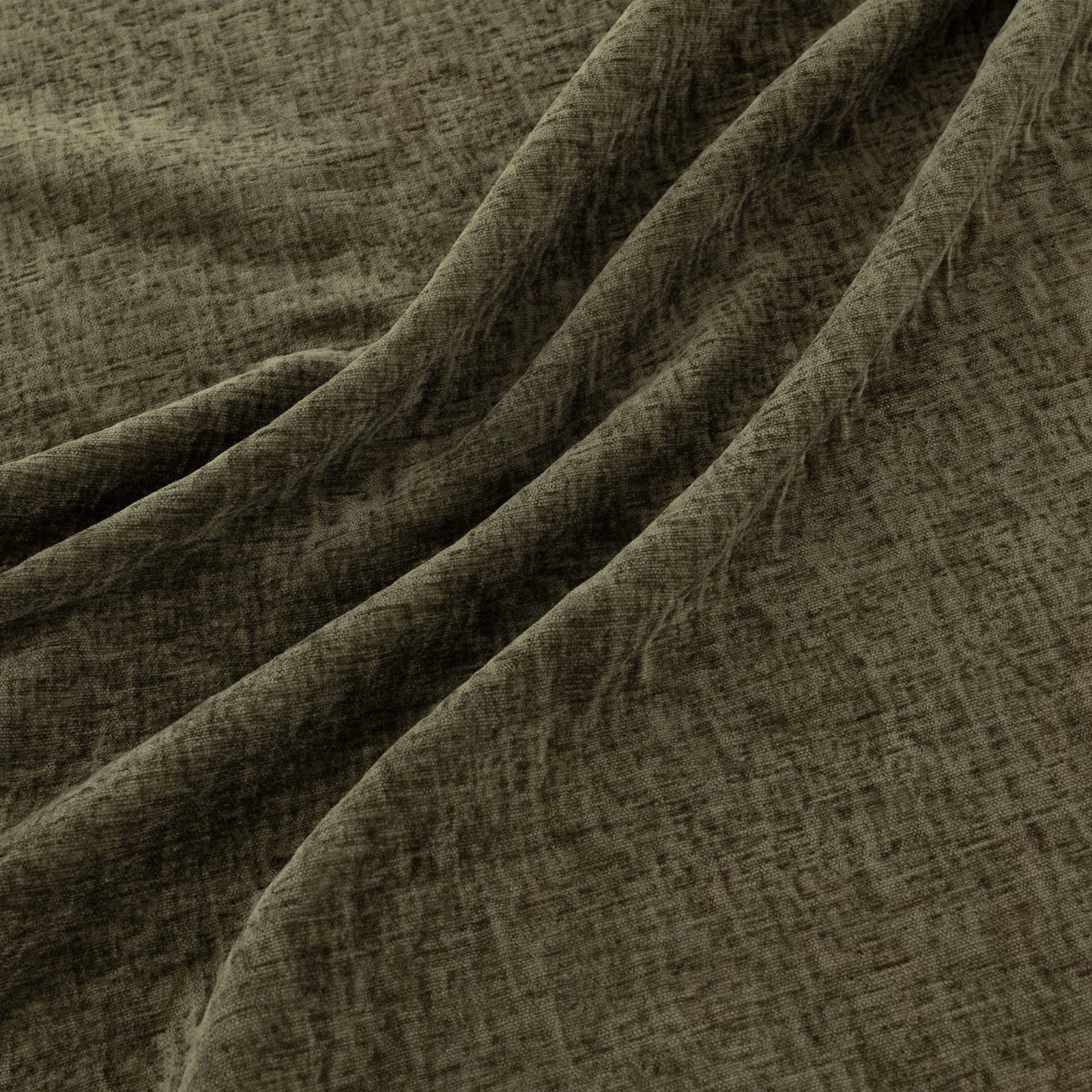 Dark pine-green woven textile with irregular crosshatching and sculptural draped folds