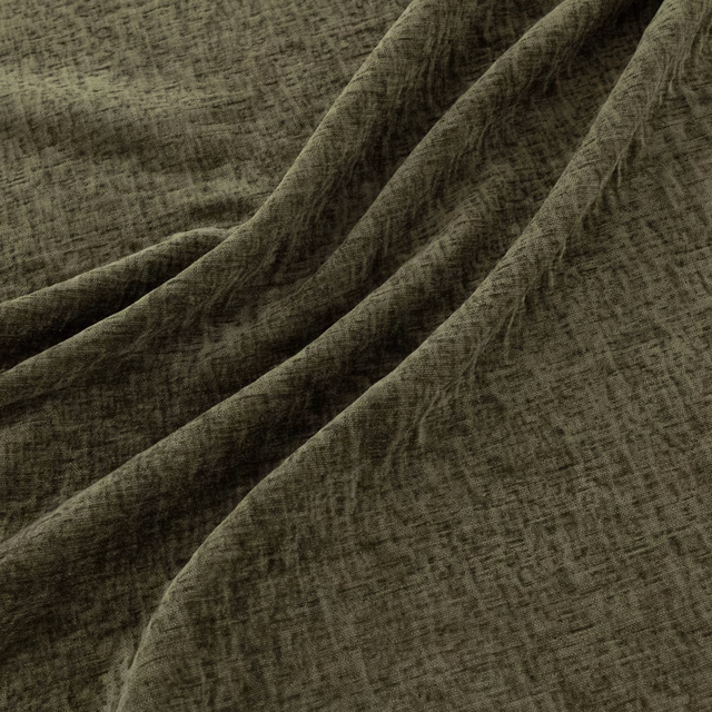 Dark pine-green woven textile with irregular crosshatching and sculptural draped folds