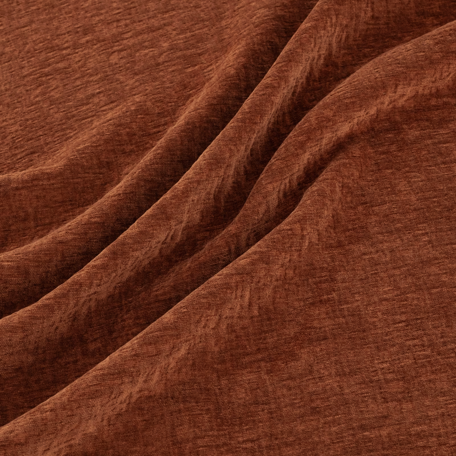 Warm Tuscan-brown textured fabric folded into soft, shadowed drapes