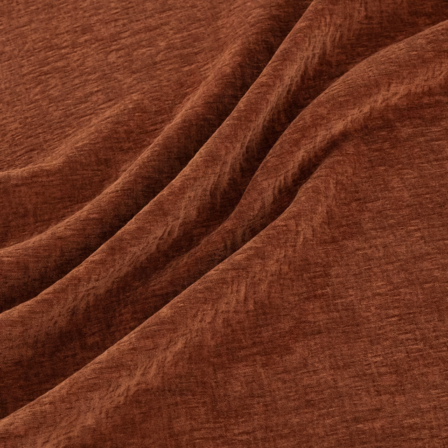 Warm Tuscan-brown textured fabric folded into soft, shadowed drapes