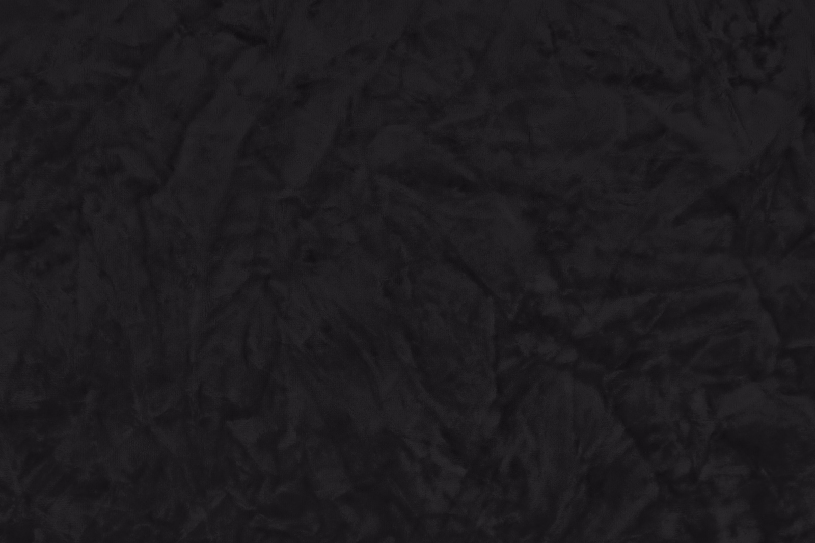 Close-up of crushed jet-black fabric with a softly rippled texture