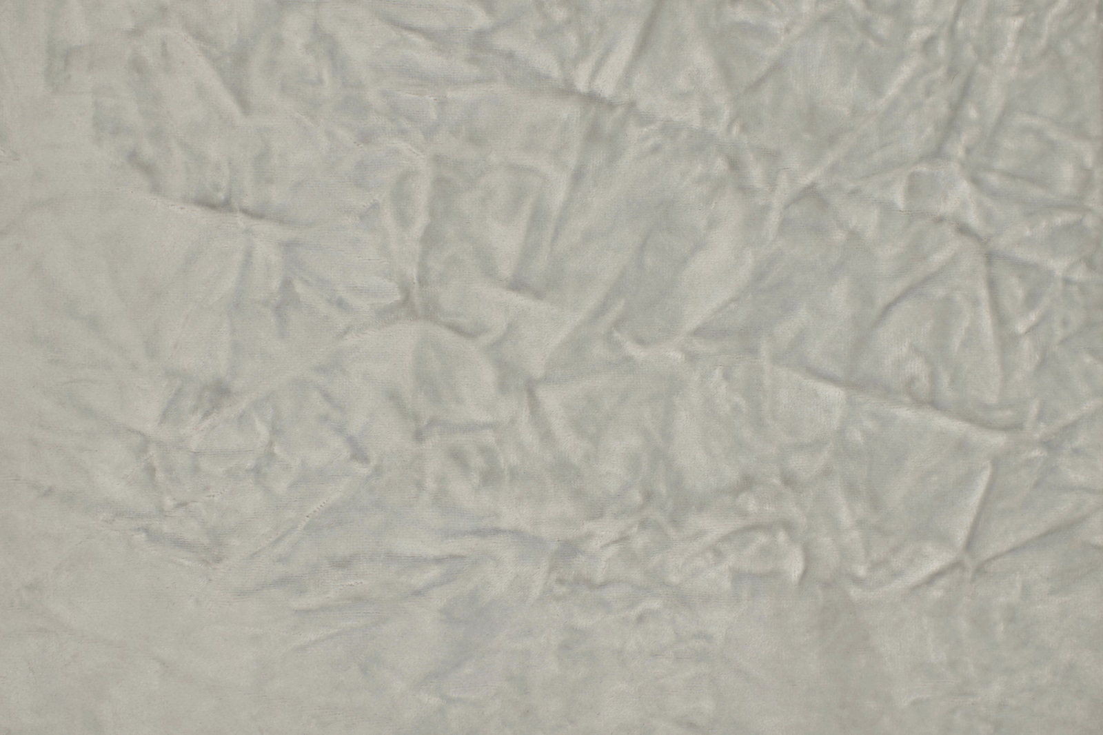Pale silver-grey crumpled plain fabric with a softly reflective textured surface