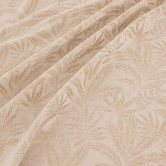 Warm natural beige fabric with softly brushed leafy botanical motifs in folded light