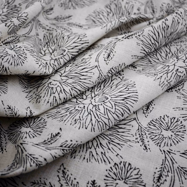 Soft grey floral fabric with black sketch-like blooms and visible woven texture