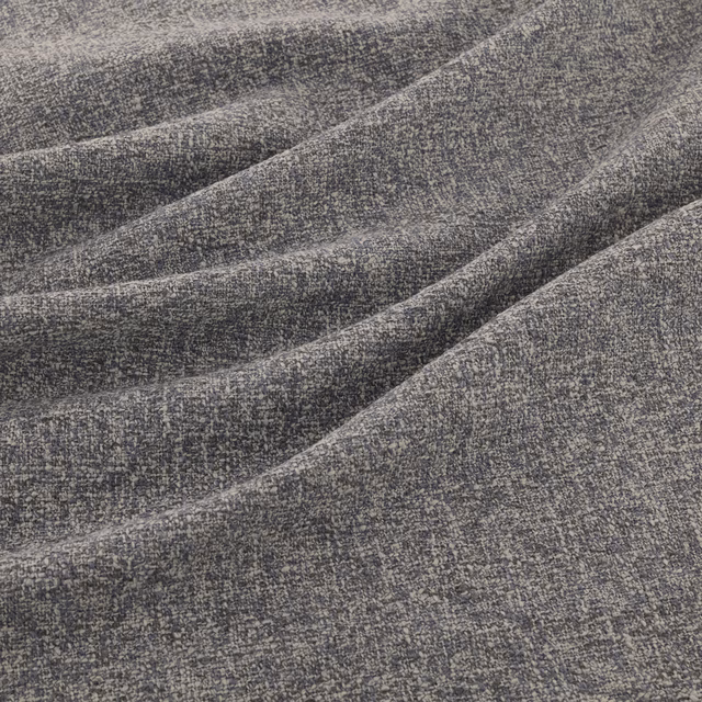 Cool charcoal-grey woven fabric with pale flecks shown in softly folded drape
