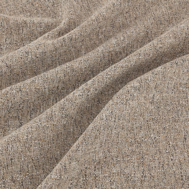 Warm biscuit beige fabric with mottled taupe weave and soft textured folds