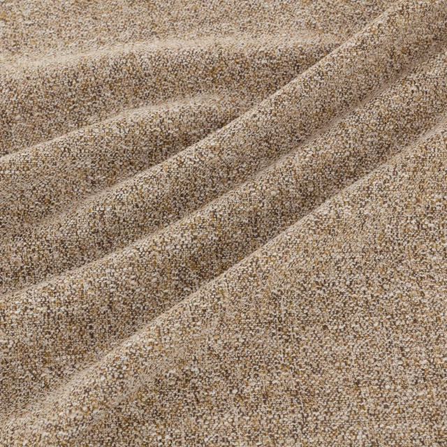 Mottled taupe-brown nubby woven fabric folded to show its dense textured surface