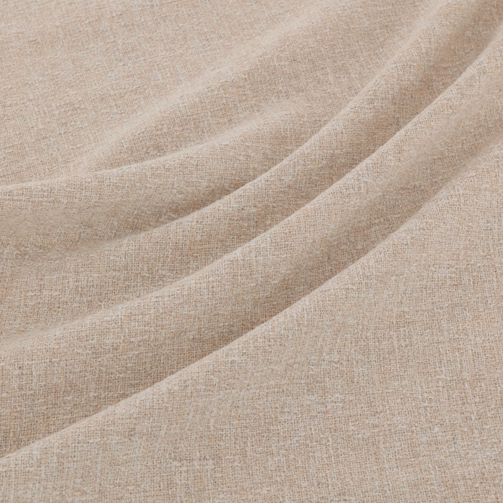 Warm beige woven fabric draped in broad folds, showing subtle natural tonal variation