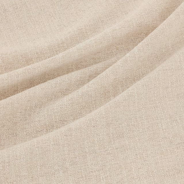 Warm oatmeal beige fabric with a fine flecked weave falling in soft folds