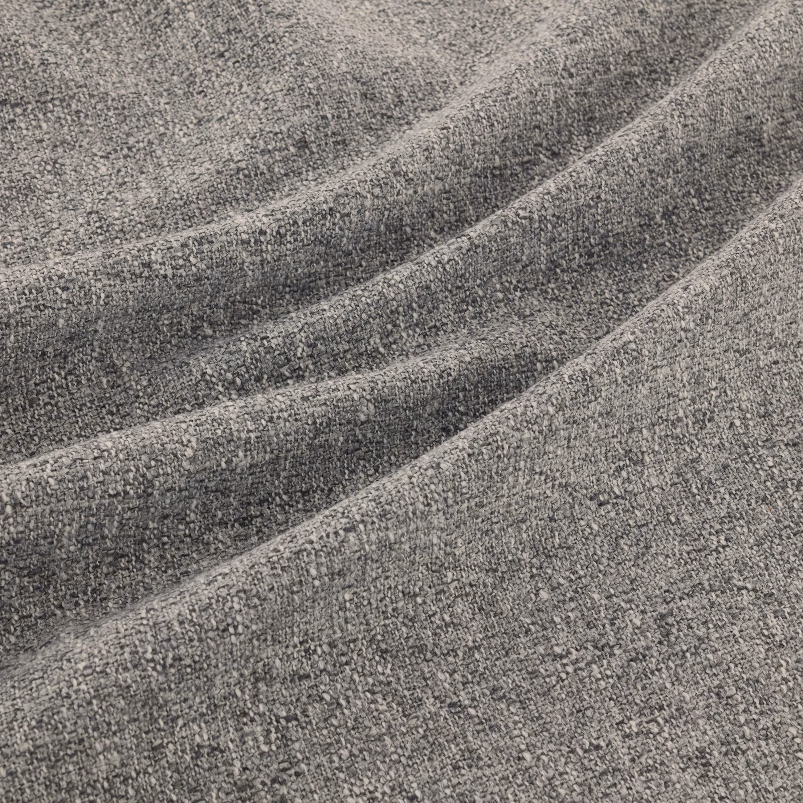 Close-up of charcoal-grey flecked weave falling into soft diagonal folds
