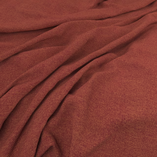 Close-up of deep rust-red fabric with a fine weave gathered into soft flowing folds