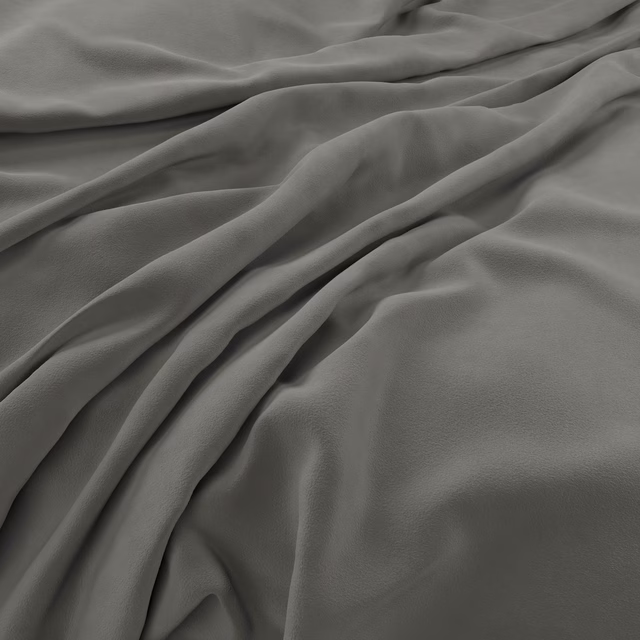 Deep charcoal-grey velvet with soft sheen gathered into broad sculptural folds