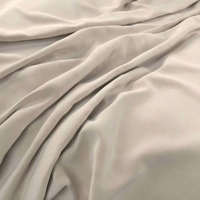 Draped pale bone velvet showing a soft nap and gentle satin sheen