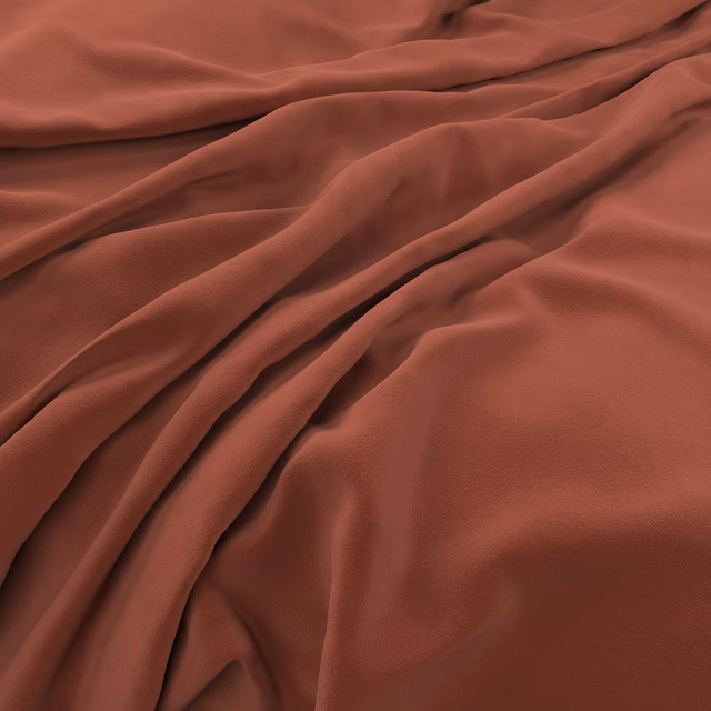 Deep brick-red velvet with soft sheen across a richly folded plush surface
