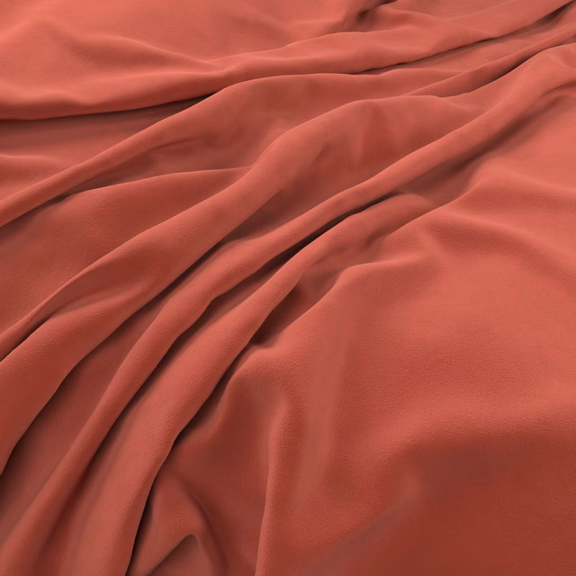 Warm coral velvet swatch with smooth plush texture and softly shaded folds