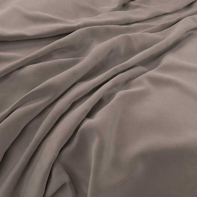 Cool taupe velvet surface forming soft folds with subtle directional sheen
