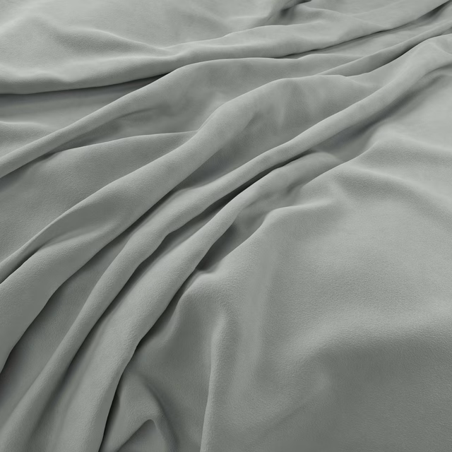 Pale grey-green velvet gathered into softly shadowed folds with a subtle brushed texture