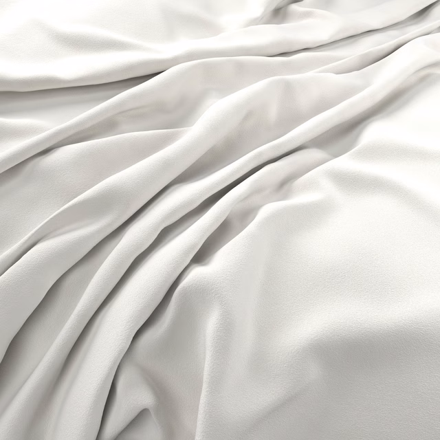 Soft ivory-white velvet draped in folds, showing a smooth subtly light-catching pile