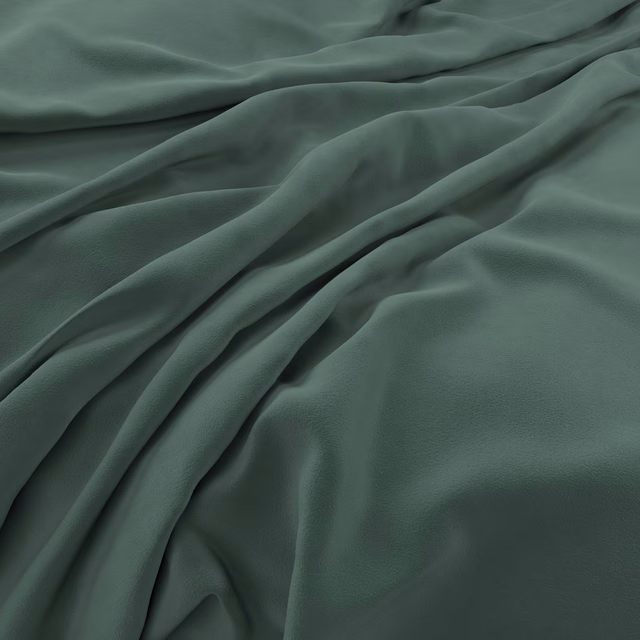 Deep pine green velvet with soft directional sheen across relaxed folds