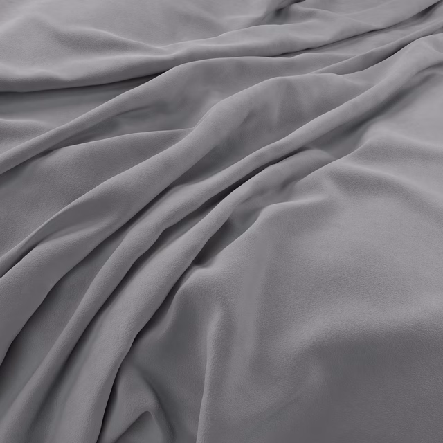 Cool silver-grey velvet with smooth pile, soft sheen, and deep flowing folds.