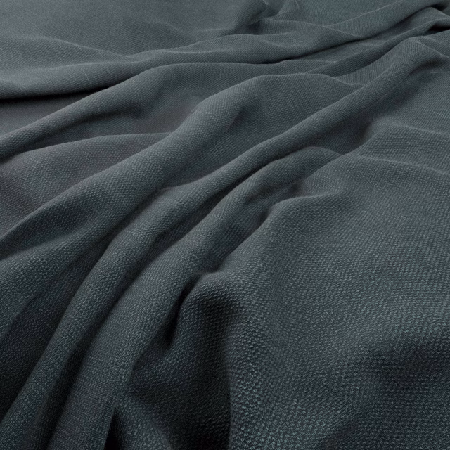 Deep evergreen woven textile with fine grain and sculptural draped folds