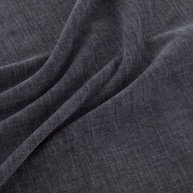 Deep charcoal denim-blue fabric with fine crosshatch weave folded into soft drapes